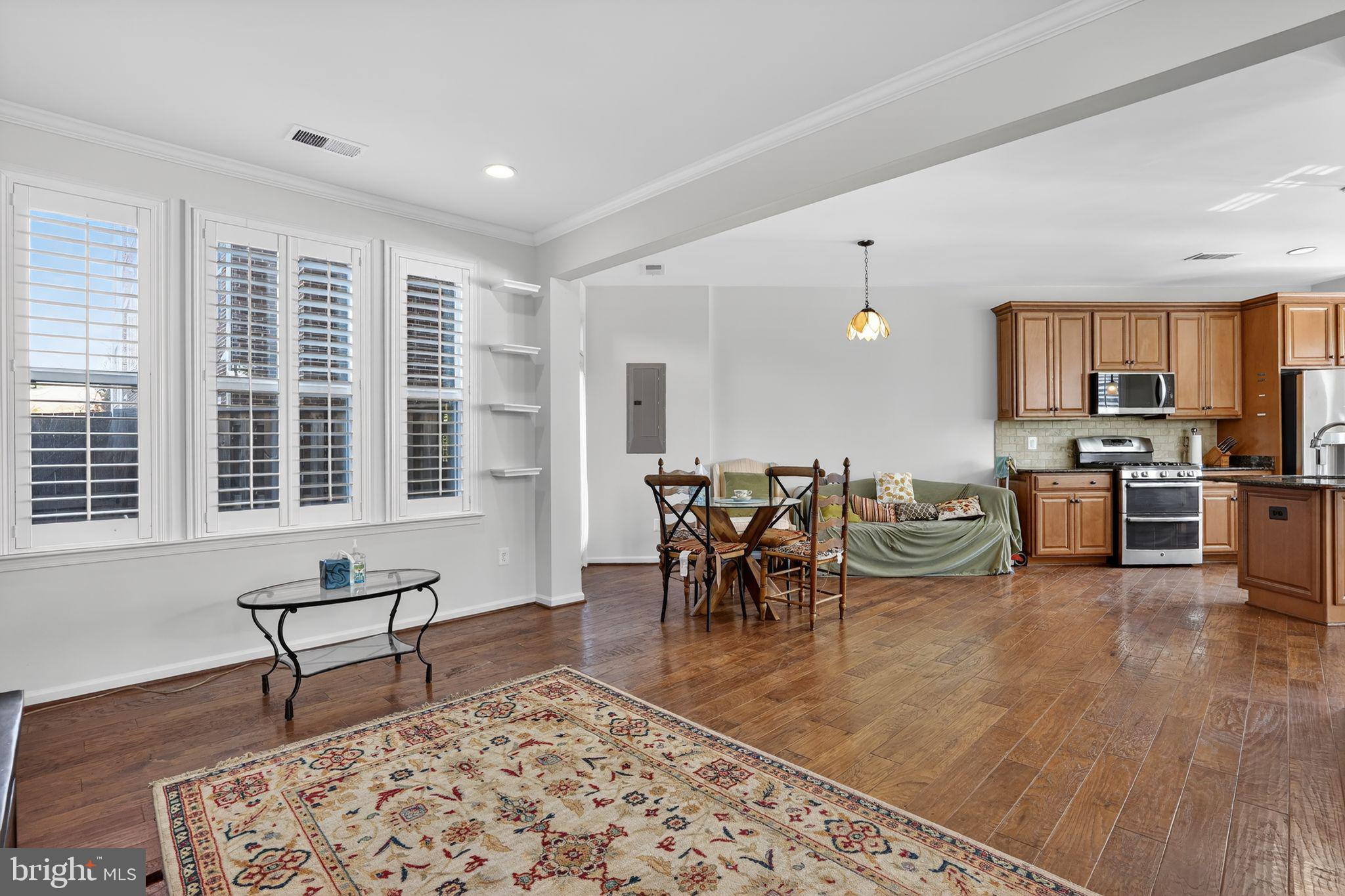 8922 Center Street Manassas, VA 20110 - Photo 7 of 24 a living room with furniture a dining table and kitchen view