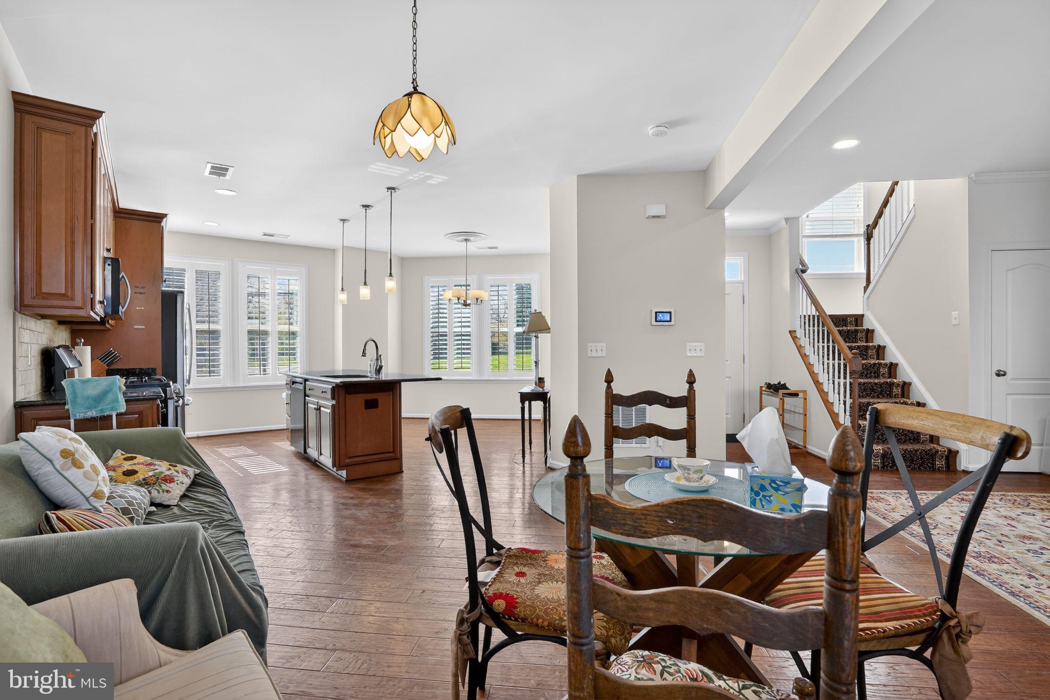 8922 Center Street Manassas, VA 20110 - Photo 8 of 24 a living room with furniture a dining table chairs and a chandelier