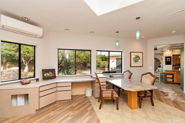 a living room with furniture a large window and a flat screen tv