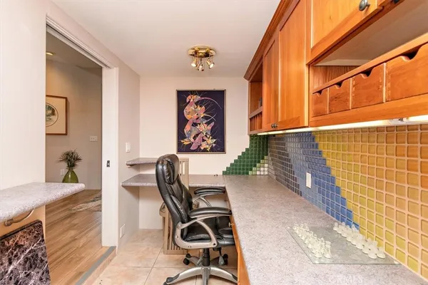 a view of a hallway with workspace and a window