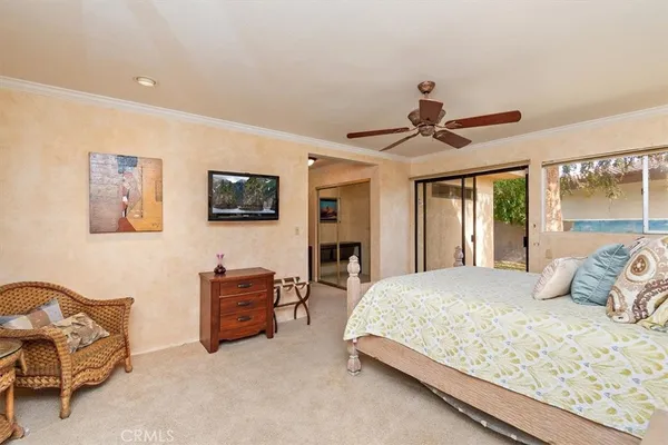 a bedroom with a bed couch and dresser