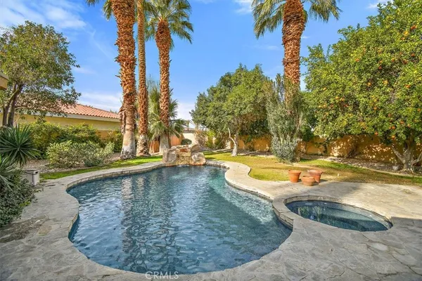 a view of a swimming pool with a yard