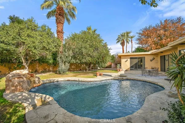 a view of a swimming pool with a patio