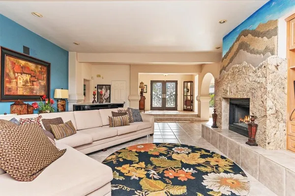 a living room with furniture and a fireplace