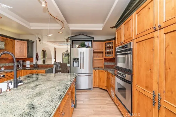 a kitchen with stainless steel appliances granite countertop a refrigerator and a sink
