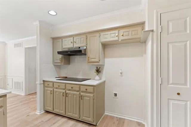 a kitchen with a sink and cabinets