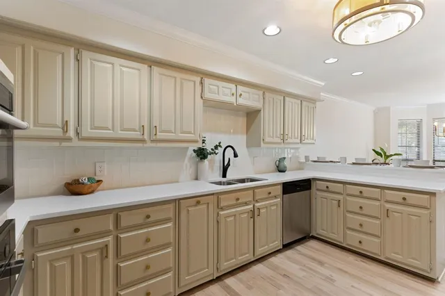 a kitchen with cabinets a sink and appliances