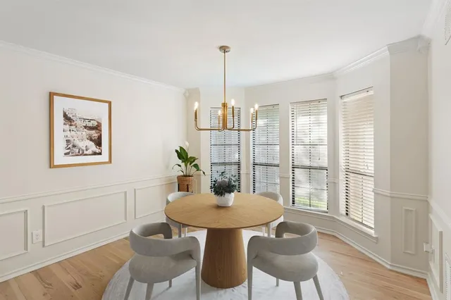 a view of a dining room with furniture window and wooden floor