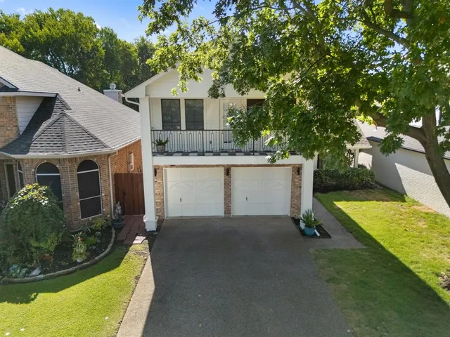 a aerial view of a house with a yard and potted plants