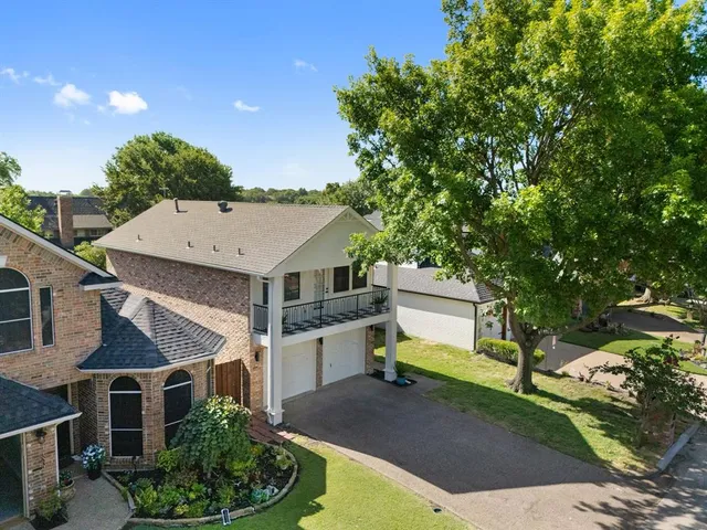 an aerial view of a house with a yard