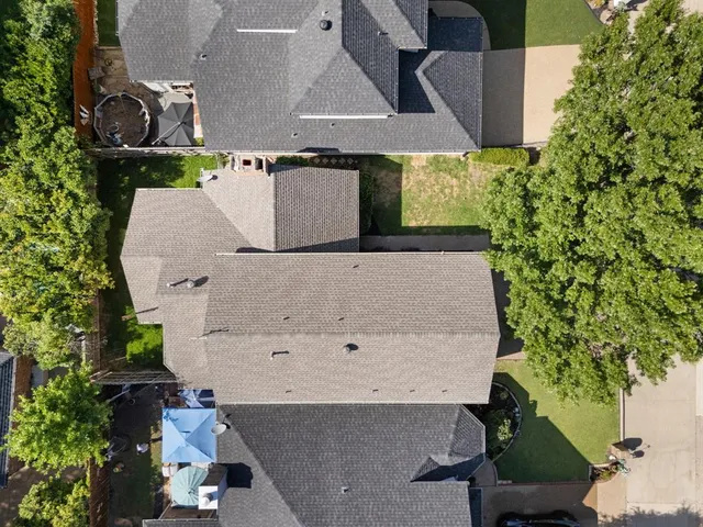 an aerial view of residential houses with outdoor space and ocean view