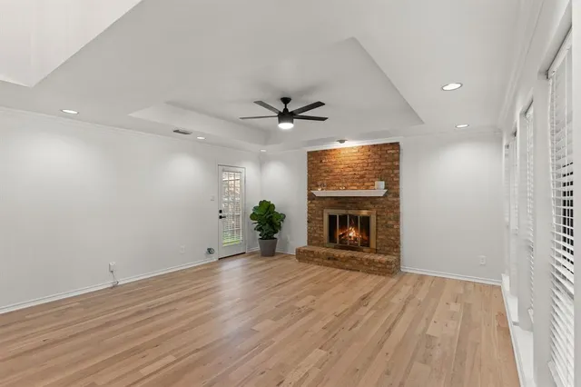 an empty room with a fireplace and windows
