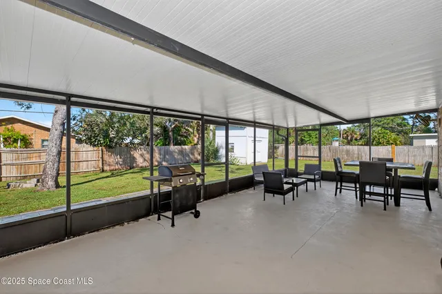 a view of a big room with furniture and floor to ceiling window