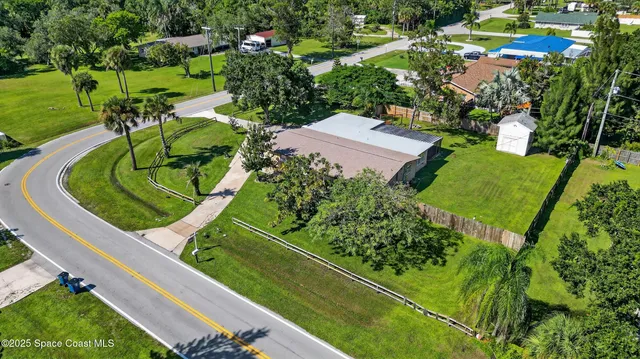 an aerial view of a residential houses with outdoor space and street view