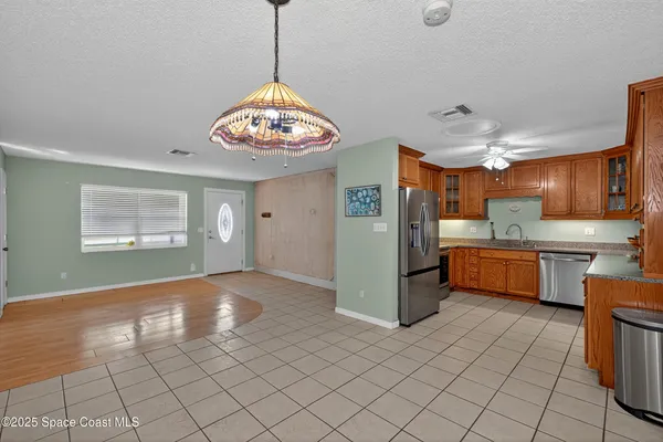 a kitchen with stainless steel appliances granite countertop a sink dishwasher stove and cabinets