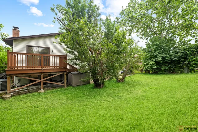 a view of backyard with a deck