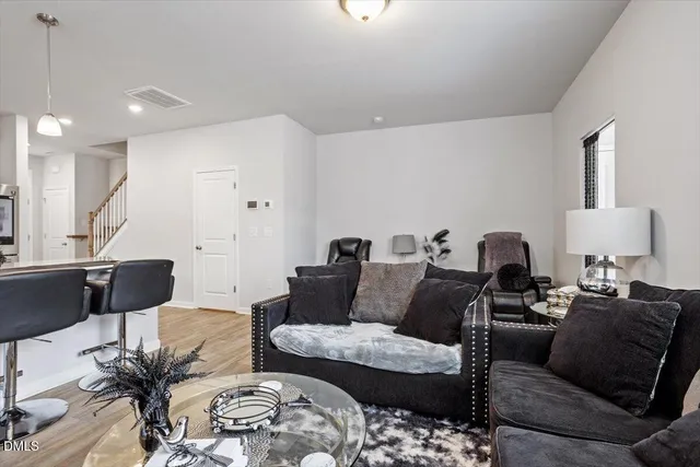 a living room with furniture and a lamp