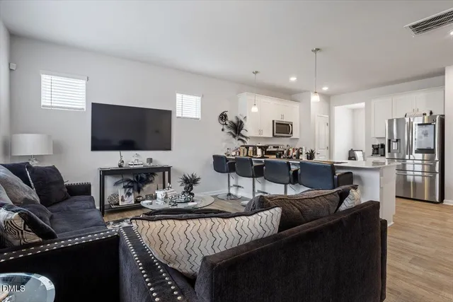 a living room with fireplace furniture and a flat screen tv