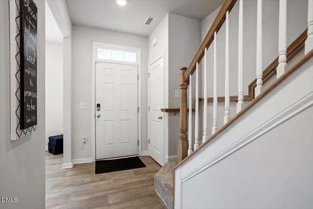 a view of an entryway with wooden floor and door