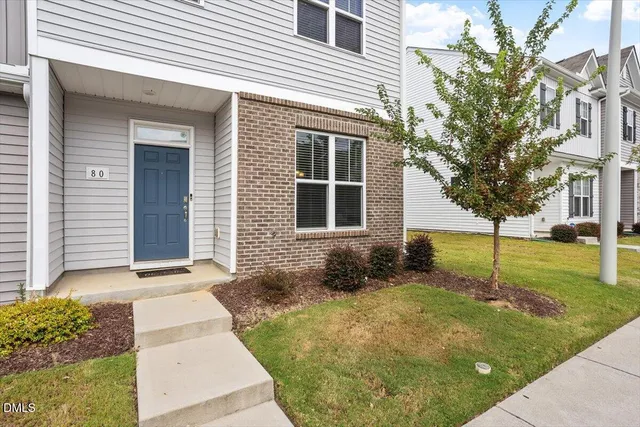 a backyard of a house with plants and trees