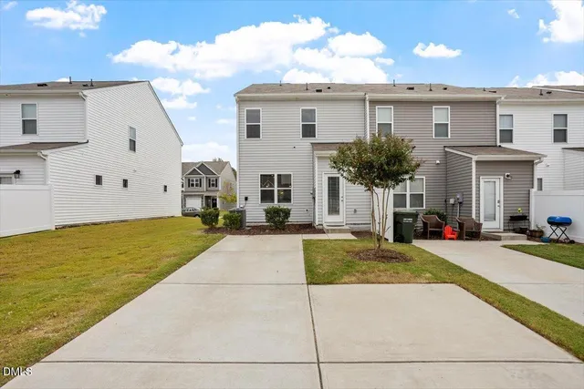 a view of house with swimming pool outdoor seating