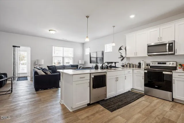a kitchen with a stove cabinets and wooden floor