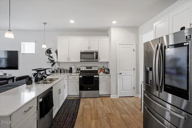 a kitchen with a sink stainless steel appliances and cabinets