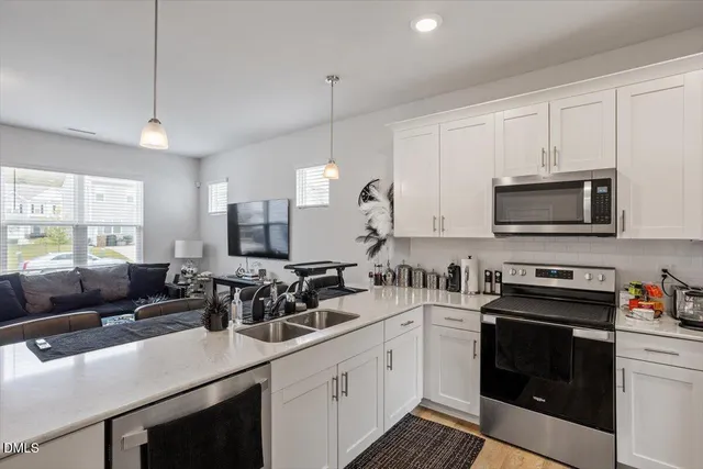 a kitchen with a sink stove top oven and microwave