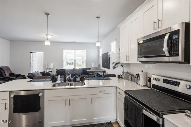 a kitchen with a sink stove and microwave