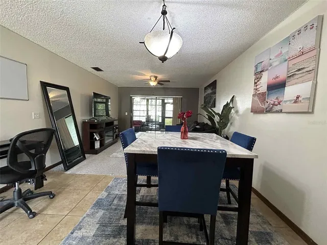 a view of a dining room with furniture and a window