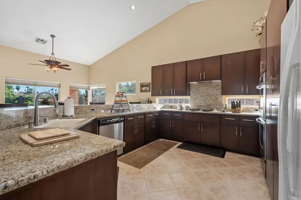 a kitchen with a sink a stove and cabinets