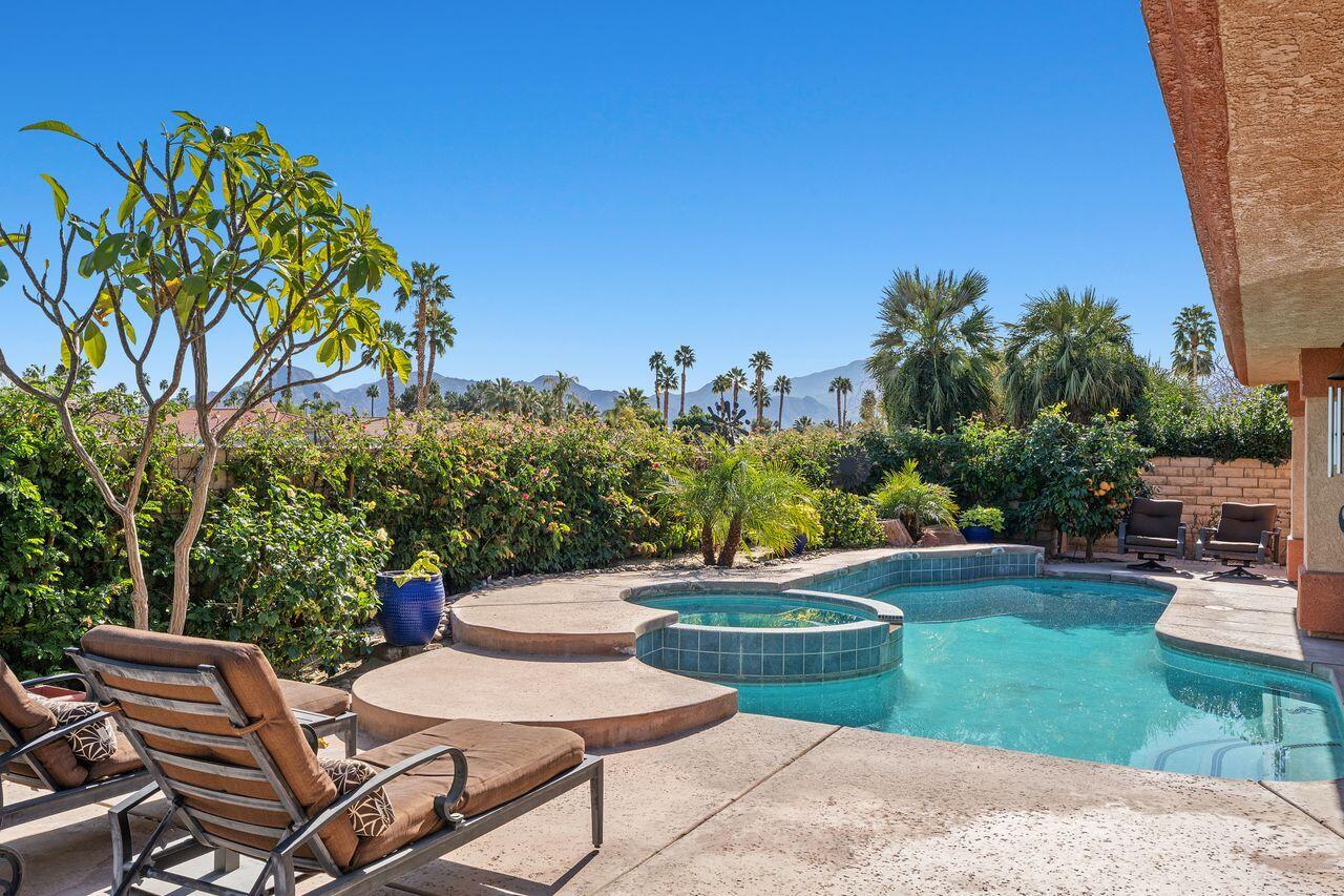 28 White Sun Way Rancho Mirage, CA 92270 - Photo 13 of 43 a view of a chairs and table in the backyard
