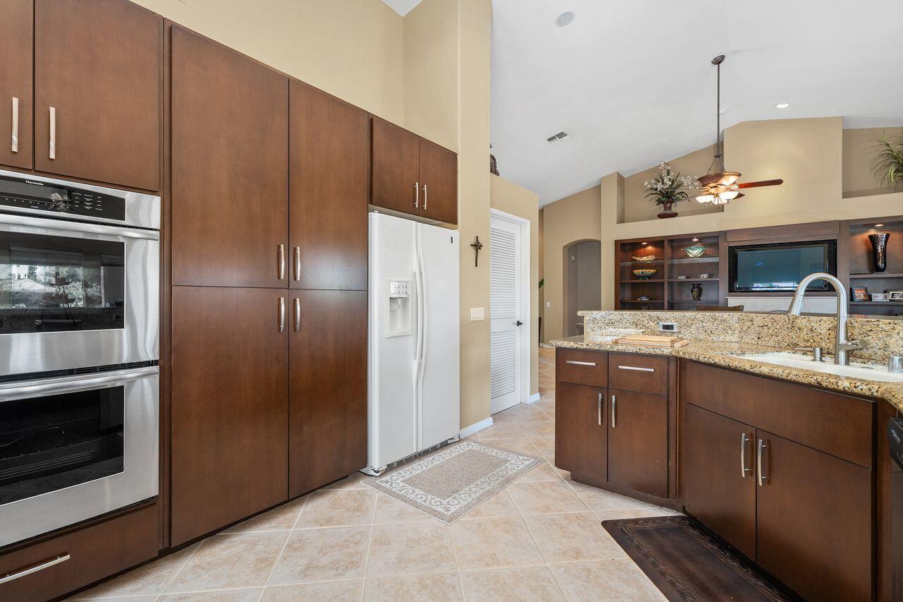 28 White Sun Way Rancho Mirage, CA 92270 - Photo 15 of 43 a kitchen with stainless steel appliances kitchen island granite countertop a refrigerator and a sink