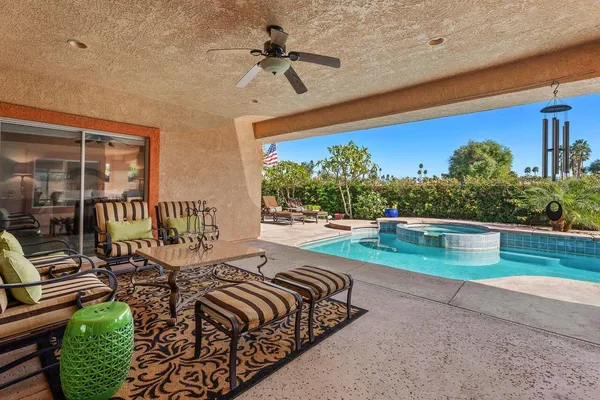 a view of swimming pool with outdoor seating