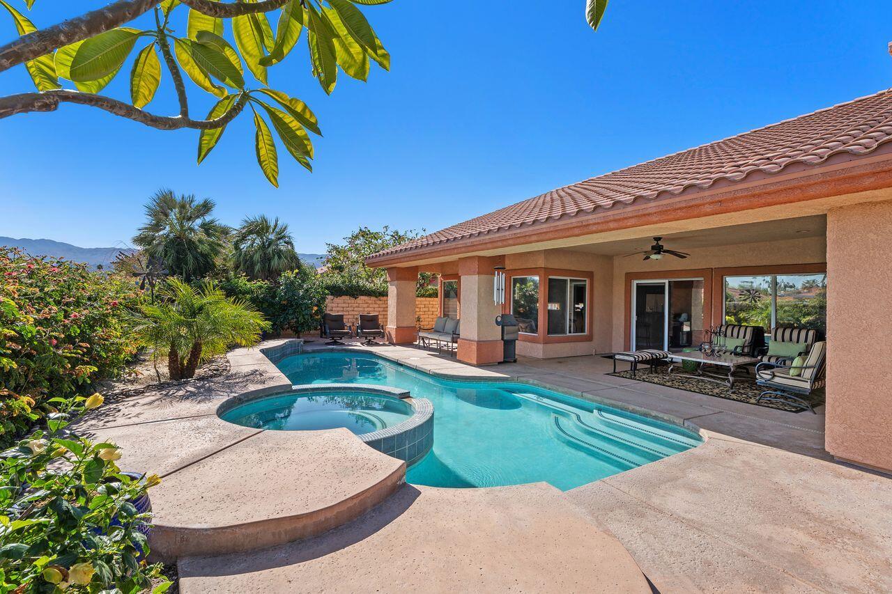 28 White Sun Way Rancho Mirage, CA 92270 - Photo 20 of 43 a view of a house with backyard sitting area and swimming pool