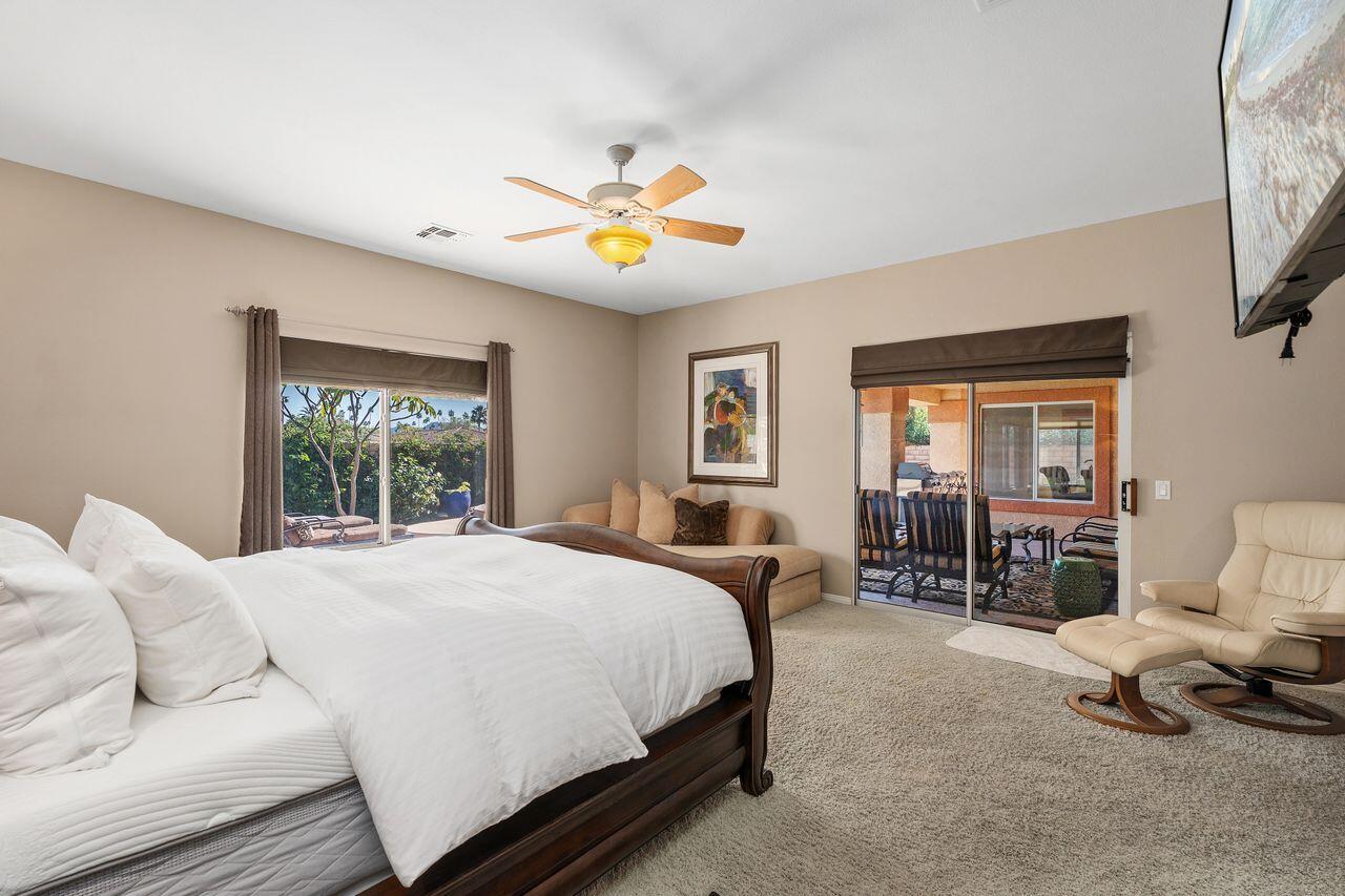 28 White Sun Way Rancho Mirage, CA 92270 - Photo 26 of 43 a bedroom with a bed and a chandelier
