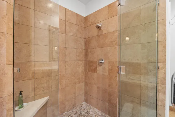a bathroom with a shower and a sink