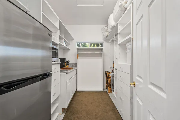 a kitchen with cabinets and stainless steel appliances