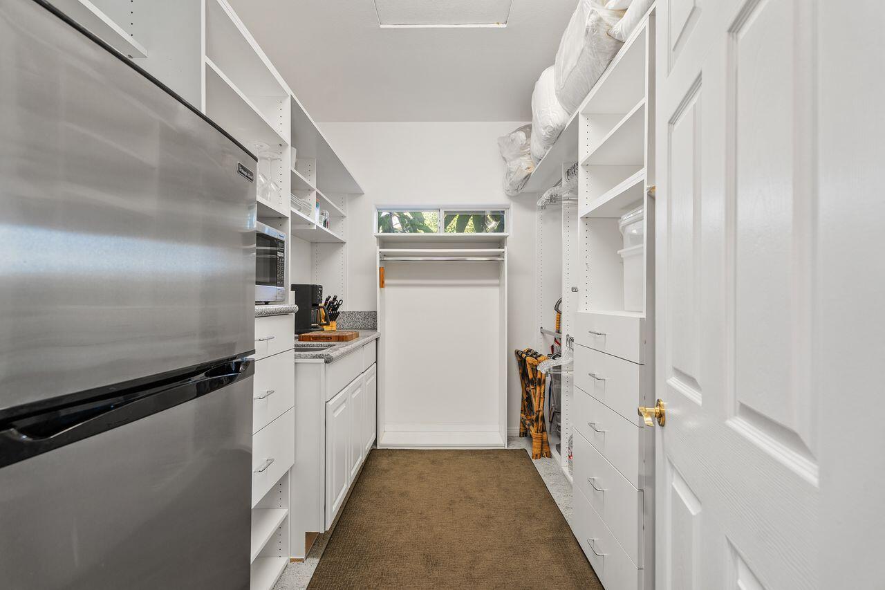 28 White Sun Way Rancho Mirage, CA 92270 - Photo 30 of 43 a kitchen with cabinets and stainless steel appliances