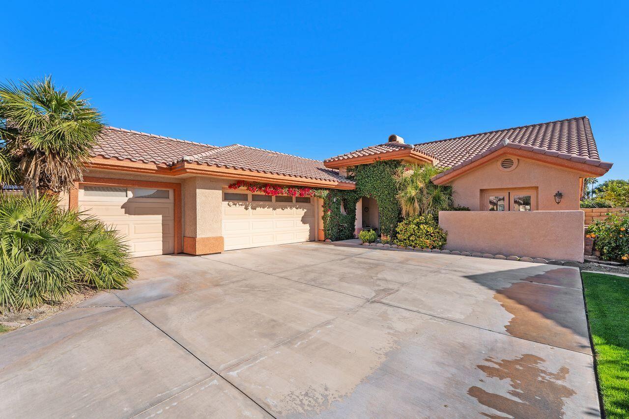 28 White Sun Way Rancho Mirage, CA 92270 - Photo 3 of 43 a front view of a house with a yard and garage