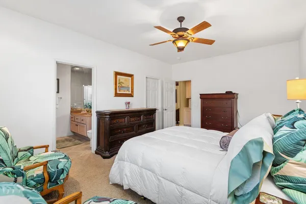 a bedroom with a bed and ceiling fan
