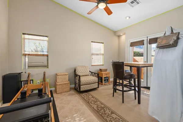 a living room with furniture a ceiling fan and a window