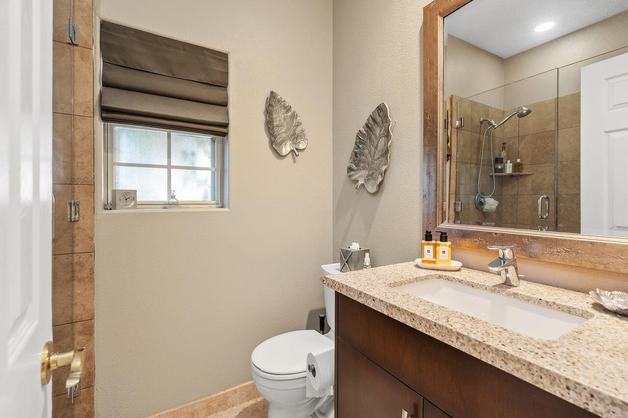 28 White Sun Way Rancho Mirage, CA 92270 - Photo 37 of 43 a bathroom with a granite countertop sink toilet and shower