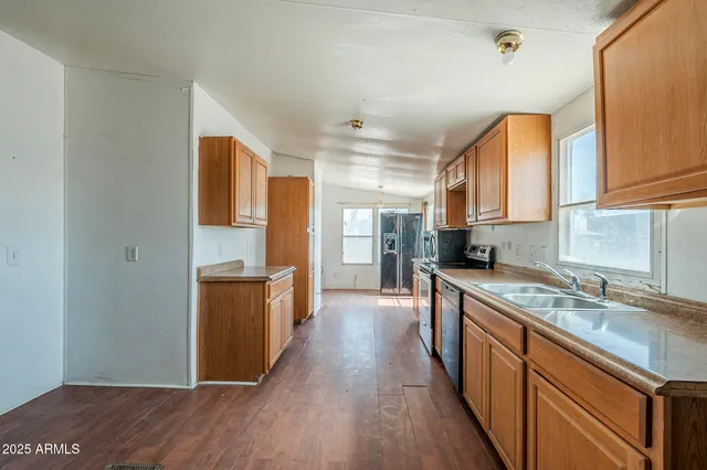 a kitchen with stainless steel appliances granite countertop wooden cabinets and a stove top oven