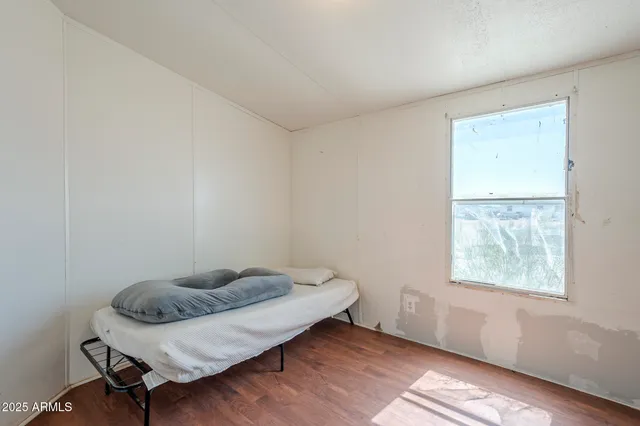 a hallway with a bed and a bookshelf