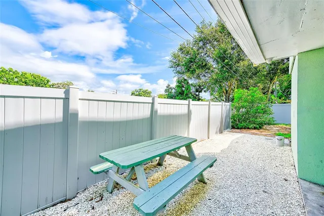 a backyard of a house with outdoor seating