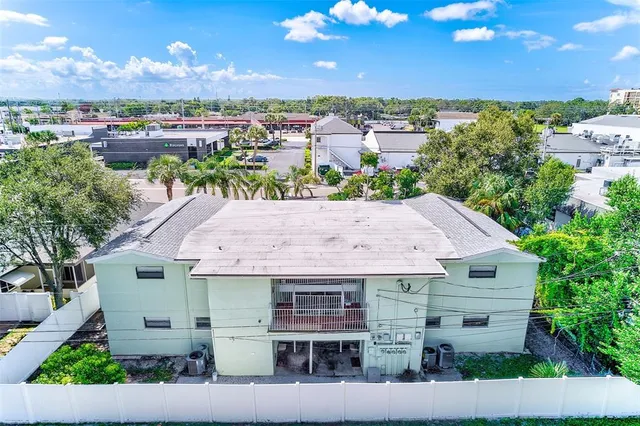 a view of backyard with a tub and wooden fence