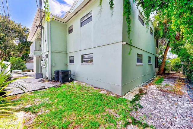 a view of a house with a backyard and a patio