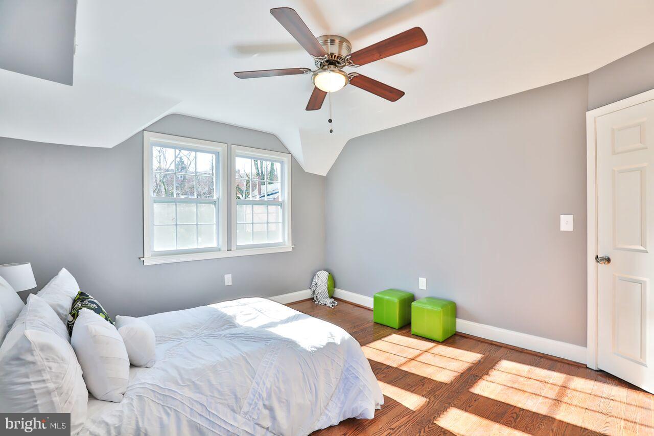 5136 Stafford Road Baltimore, MD 21229 - Photo 17 of 30 a bedroom with a bed and a chandelier
