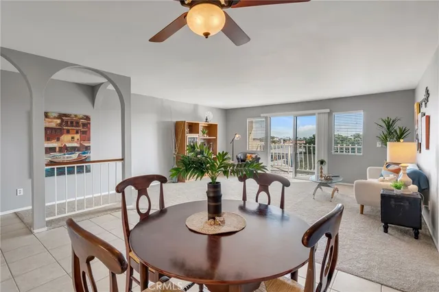 a view of a dining room with furniture large windows and wooden floor
